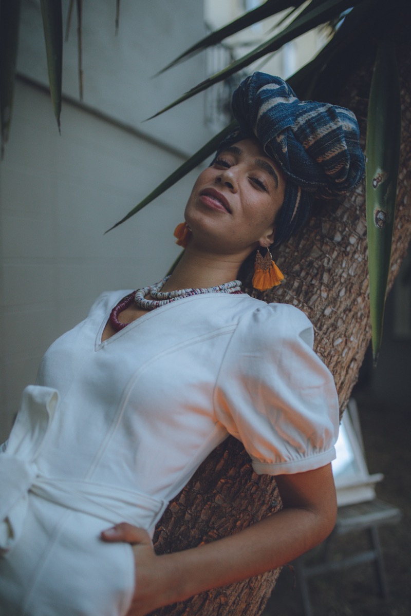 Simago portrait with headwrap and palm tree