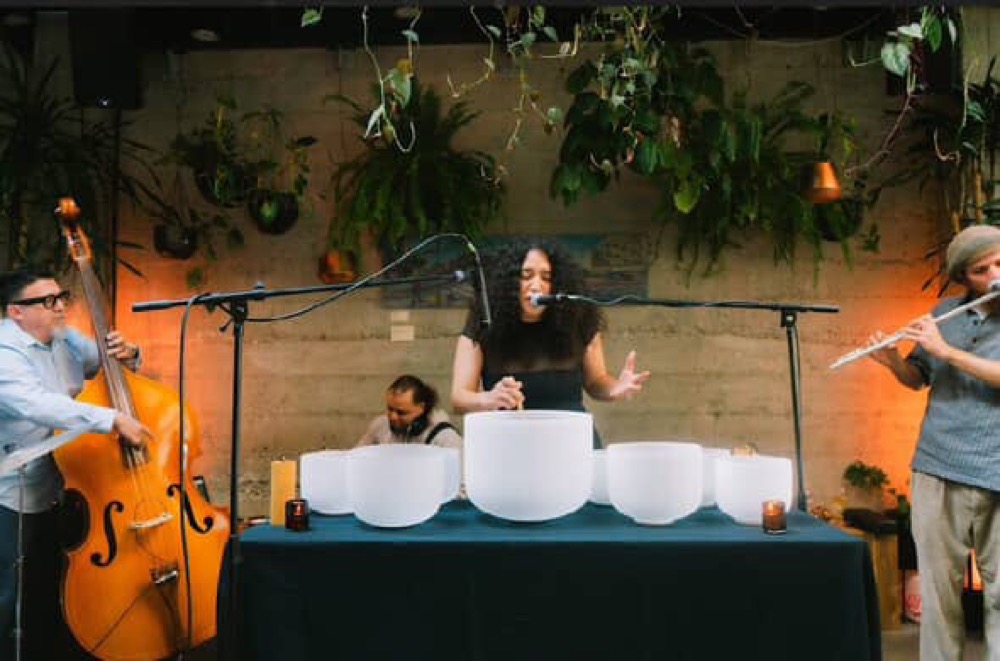 Simago performing sound healing with singing bowls
